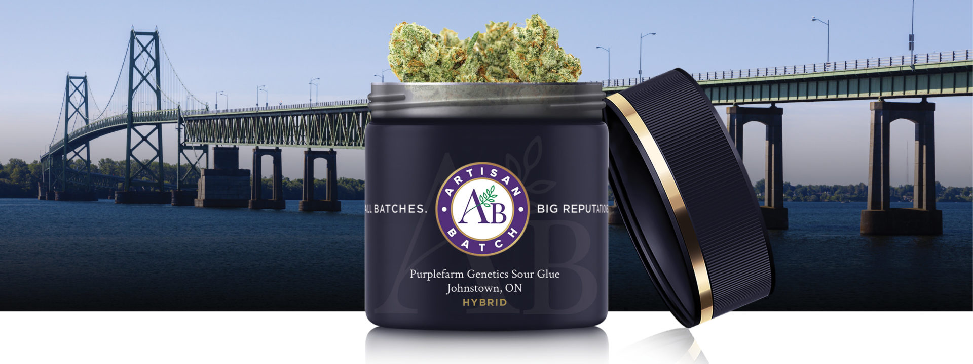 Beauty jar of Purplefarm Genetics with lid off and bud peeking out of open top. Background image is the Johnston Ontario bridge crossing the river