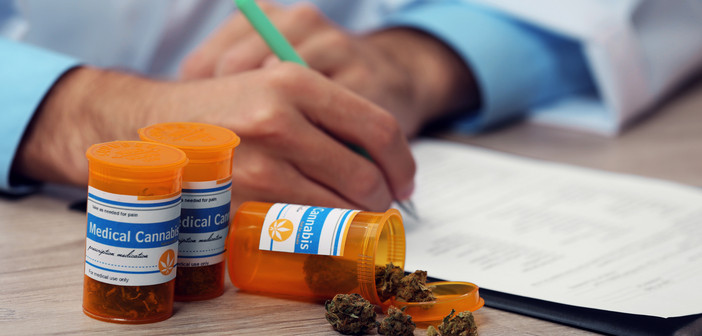 a doctor writing on a pad with some medical cannabis in front of him to show how to talk to your doctor about medical cannabis